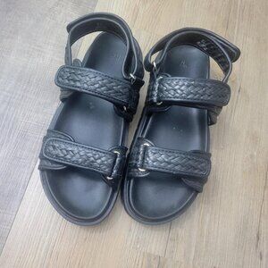 Size 10 Black braided sandals with rounded, open toes and adjustable foot